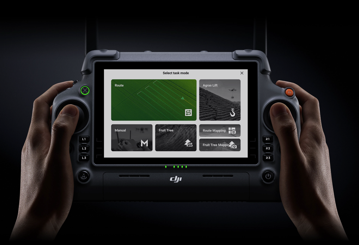 Person holding a DJI device with a screen displaying a menu on a dark background